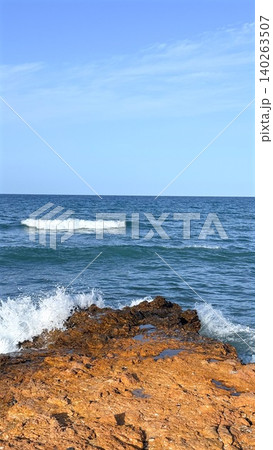 Coastal Scene Beauty. Cliff Views Meet Ocean. Seaside Cliff With Textured Rocks And Bright Sky. Dramatic Headland Overlooking Ocean With Rugged Foreground And Vibrant Horizon 140263507