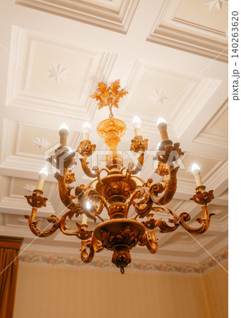 Elegant ceiling design with traditional chandelier. Concept of historical style and refined decor elements. Elegant ceiling design with traditional chandelier. Concept of historical style and refined decor elements. 140263620