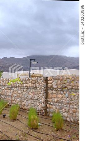 Ancient Wall Ambiance. Overcast Sky With Rustic Features. Old Stone Structure With Soft Lighting Ambiance. Weathered Masonry Beneath Cloudy Sky With Subtle Illumination Ancient Wall Ambiance. Overcast Sky With Rustic Features. Old Stone Structure With Soft Lighting Ambiance. Weathered Masonry Beneath Cloudy Sky With Subtle Illumination 140263996