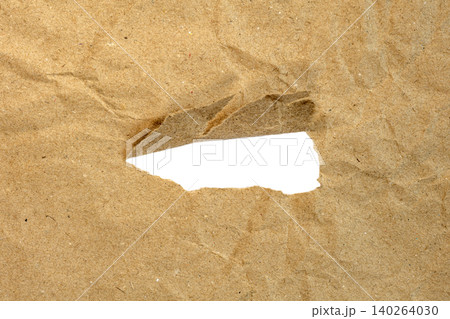 Brown kraft paper torn revealing transparent background checkerboard texture effect Brown kraft paper torn revealing transparent background checkerboard texture effect 140264030