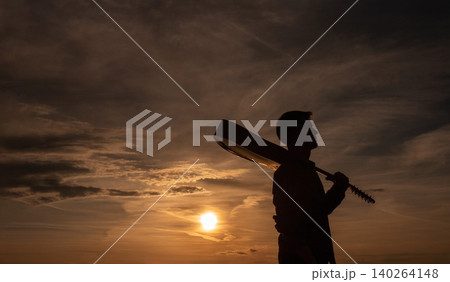 Silhouette of Male Musician with Acoustic Guitar at Sunset Silhouette of Male Musician with Acoustic Guitar at Sunset 140264148
