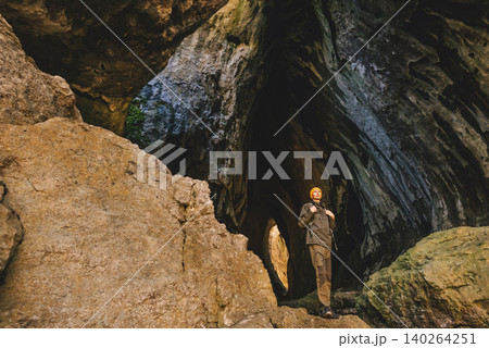 Man Adventurer Standing on Cliff inside Cave Man Adventurer Standing on Cliff inside Cave 140264251