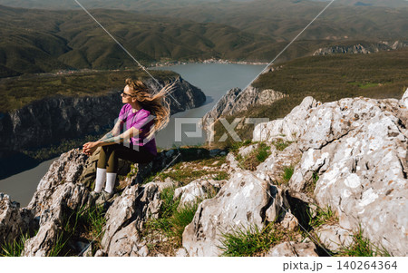 Female Hiker Enjoying Panoramic Mountain View 140264364