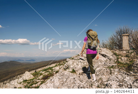 Female Hiker Climbing Rocky Mountain Trail Female Hiker Climbing Rocky Mountain Trail 140264411