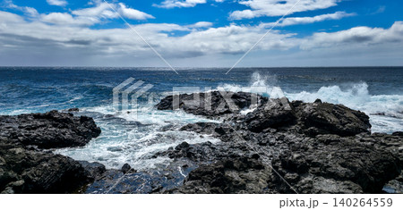 Rocky coastline with crashing waves under a blue sky featuring scattered clouds and a distant horizon, showcasing the natural beauty of the ocean landscape. High quality photo Rocky coastline with crashing waves under a blue sky featuring scattered clouds and a distant horizon, showcasing the natural beauty of the ocean landscape. High quality photo 140264559
