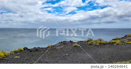 Scenic coastal landscape featuring a volcanic cone, lush greenery, and a clear blue sky over the ocean horizon with gentle waves and distant clouds. High quality photo Scenic coastal landscape featuring a volcanic cone, lush greenery, and a clear blue sky over the ocean horizon with gentle waves and distant clouds. High quality photo 140264641