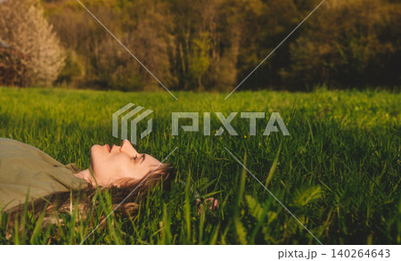 Woman Resting in Green Grass Mindfulness and Relaxation Woman Resting in Green Grass Mindfulness and Relaxation 140264643