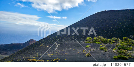Scenic view of volcanic landscape with black soil, green vegetation, and blue ocean under a clear sky on the island of La Palma in the Canary Islands. High quality photo Scenic view of volcanic landscape with black soil, green vegetation, and blue ocean under a clear sky on the island of La Palma in the Canary Islands. High quality photo 140264677
