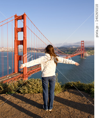 Woman overlooking Golden Gate Bridge from Marin Headlands viewpoint Woman overlooking Golden Gate Bridge from Marin Headlands viewpoint 140265010