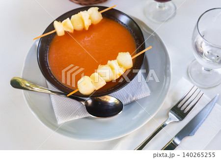 Gazpacho with slices of melon on skewers Gazpacho with slices of melon on skewers 140265255