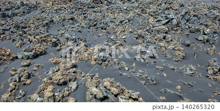 Black volcanic landscape with hardened lava formations and sparse vegetation on Island La Palma after the eruption of the Tajogaite volcano. High quality photo Black volcanic landscape with hardened lava formations and sparse vegetation on Island La Palma after the eruption of the Tajogaite volcano. High quality photo 140265320