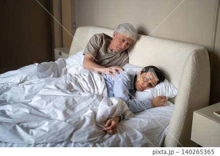 Ignoring stressed senior wife treating elderly husband with coldness and silence after couple brawl. Ignoring stressed senior wife treating elderly husband with coldness and silence after couple brawl. 140265365