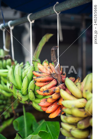 Bunches of bananas in varying level of ripeness selling at traditional local fruit market in Bangkok 140265666