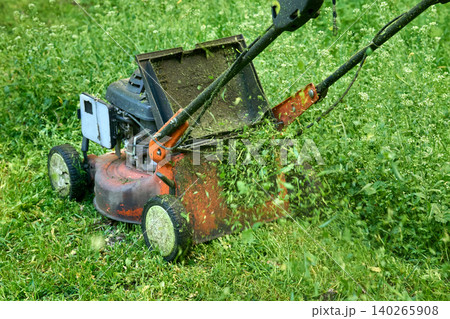 Lawn service.Summer grass cutting with handle mower Lawn service.Summer grass cutting with handle mower 140265908