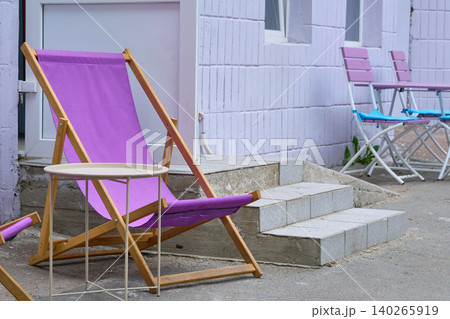 Fold out lounge chair and coffee table near the store entrance Fold out lounge chair and coffee table near the store entrance 140265919
