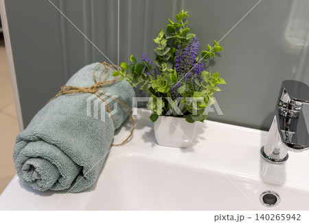 Modern Bathroom Basin Detail with Rolled Towel and Potted Lavender Plant 140265942