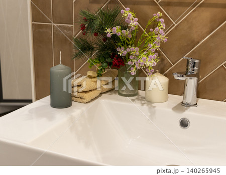Modern Bathroom Basin Detail with Rolled Towel and Potted Lavender Plant Modern Bathroom Basin Detail with Rolled Towel and Potted Lavender Plant 140265945
