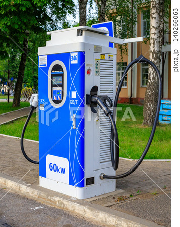 EV charging station interface screen with green cable plug, green energy public electric vehicle power supply unit EV charging station interface screen with green cable plug, green energy public electric vehicle power supply unit 140266063