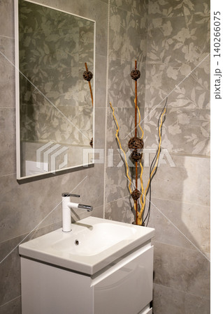 Contemporary Restroom Decor Featuring Ceramic Sink and Textured Geometric Wall 140266075