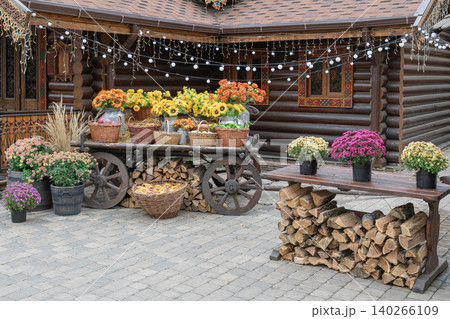 Market setup with flowers and produce in a garden Market setup with flowers and produce in a garden 140266109