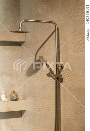Contemporary Washroom Design Featuring Gold Rainfall Shower and Chevron Wall 140266191