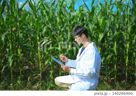 Agricultural researcher recording crop results on clipboard Agricultural researcher recording crop results on clipboard 140266400