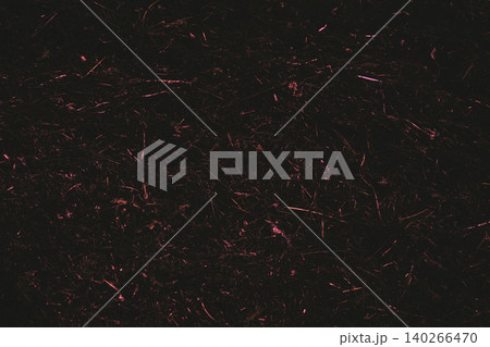 Dark night shiny debris of fallen dry reeds with a red hue Dark night shiny debris of fallen dry reeds with a red hue 140266470