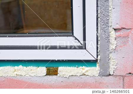 Construction installing.Metal plastic window on pink brick wall 140266501