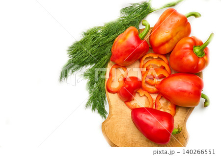 Green dill and sweet red ripe pepper on cutting board Green dill and sweet red ripe pepper on cutting board 140266551