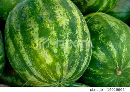 Summer joy. Pile of ripe watermelons at the market 140266684