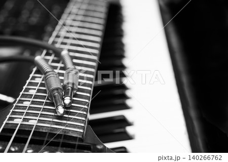 Electric guitar,synth keyboard and cable with jacks for connection Electric guitar,synth keyboard and cable with jacks for connection 140266762