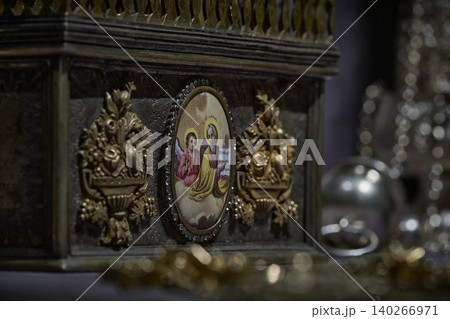 Ornate Orthodox church chalice with icon of Jesus Christ, religious liturgical object close up Ornate Orthodox church chalice with icon of Jesus Christ, religious liturgical object close up 140266971