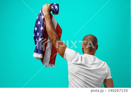 Back view of a black man holding USA flag Back view of a black man holding USA flag 140267150