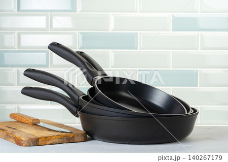 Clean and dry cooking pans on a kitchen counter Clean and dry cooking pans on a kitchen counter 140267179