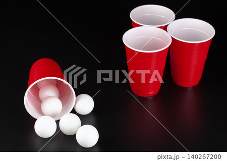 Red plastic cups and ball for game of beer pong Red plastic cups and ball for game of beer pong 140267200