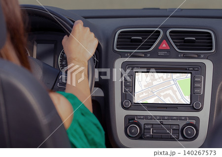 Driver using a GPS map to find a taxi location in the city while driving 140267573