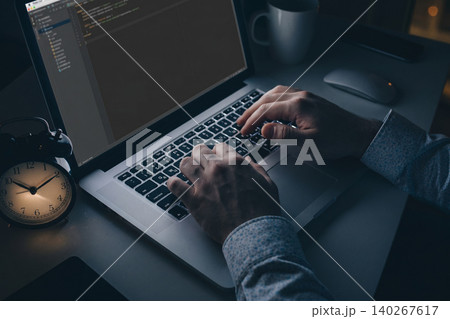 Typing a scam message at night while using a laptop in a dark room Typing a scam message at night while using a laptop in a dark room 140267617