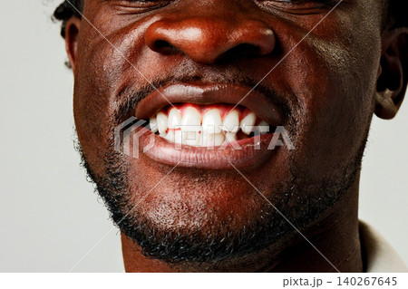 Smiling man shows white teeth with clear background in indoor setting Smiling man shows white teeth with clear background in indoor setting 140267645