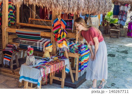 Female tourist walks through colonial architecture, craft shops and agave gardens, showing Mexico travel and cultural discovery concept Female tourist walks through colonial architecture, craft shops and agave gardens, showing Mexico travel and cultural discovery concept 140267711