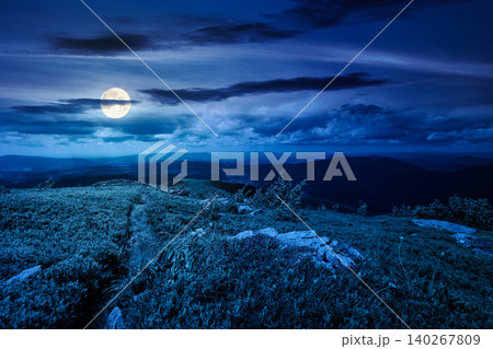 mountain landscape with alpine meadow in mysterious light at night. full moon over carpathian mountain scenery in summer. view in to the distant valley landscape. rolling hills and grassy meadow mountain landscape with alpine meadow in mysterious light at night. full moon over carpathian mountain scenery in summer. view in to the distant valley landscape. rolling hills and grassy meadow 140267809