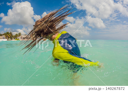 Teen boy swimming alone in turquoise Caribbean sea, enjoying tropical water, sunny beach vacation, active childhood and summer travel concept Teen boy swimming alone in turquoise Caribbean sea, enjoying tropical water, sunny beach vacation, active childhood and summer travel concept 140267872