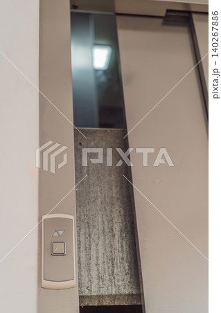 Elevator stuck between floors with doors open, showing lift malfunction, building safety issue, urban infrastructure problem and emergency risk concept Elevator stuck between floors with doors open, showing lift malfunction, building safety issue, urban infrastructure problem and emergency risk concept 140267886