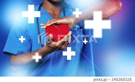Medical professional holds a heart symbol during a healthcare activity 140268328