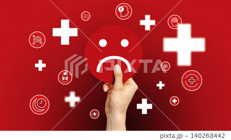Hand holding sad face symbol with health icons on red background in a bold design Hand holding sad face symbol with health icons on red background in a bold design 140268442