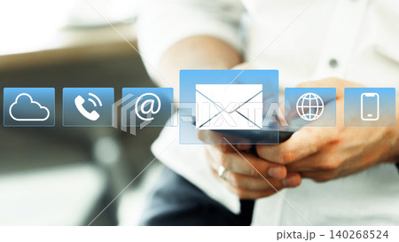 Person using mobile phone to check messages and news updates online in an office setting 140268524