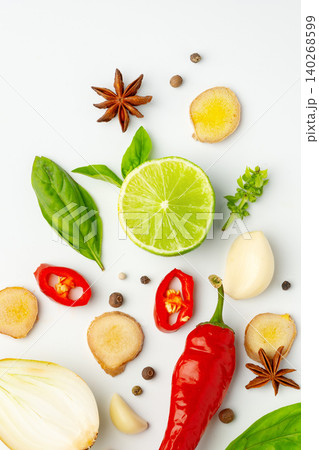 Ingredients laid out for cooking with herbs, spices, and fresh produce on a white background Ingredients laid out for cooking with herbs, spices, and fresh produce on a white background 140268599
