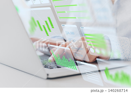 Person working with digital business chart data on a laptop in a modern office setting Person working with digital business chart data on a laptop in a modern office setting 140268714
