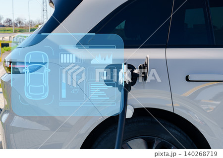 Electric car charging station in a city with digital display in the background Electric car charging station in a city with digital display in the background 140268719