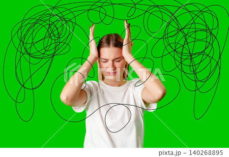 Woman holding her head with tangled lines over her mind on a green background Woman holding her head with tangled lines over her mind on a green background 140268895