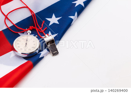 Metal Sport Whistle And Stopwatch On American Flag Metal Sport Whistle And Stopwatch On American Flag 140269400